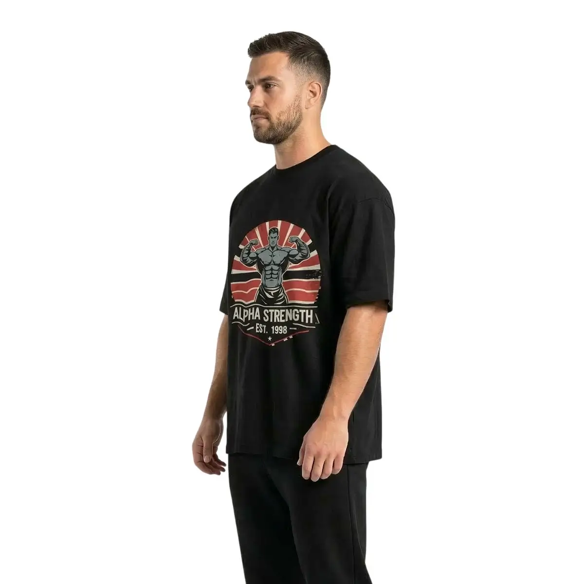 A three-quarter profile view of a male model wearing the black "Alpha Strength" oversized tee, highlighting the substantial heavyweight cotton fabric and the detailed retro print, on a white background.